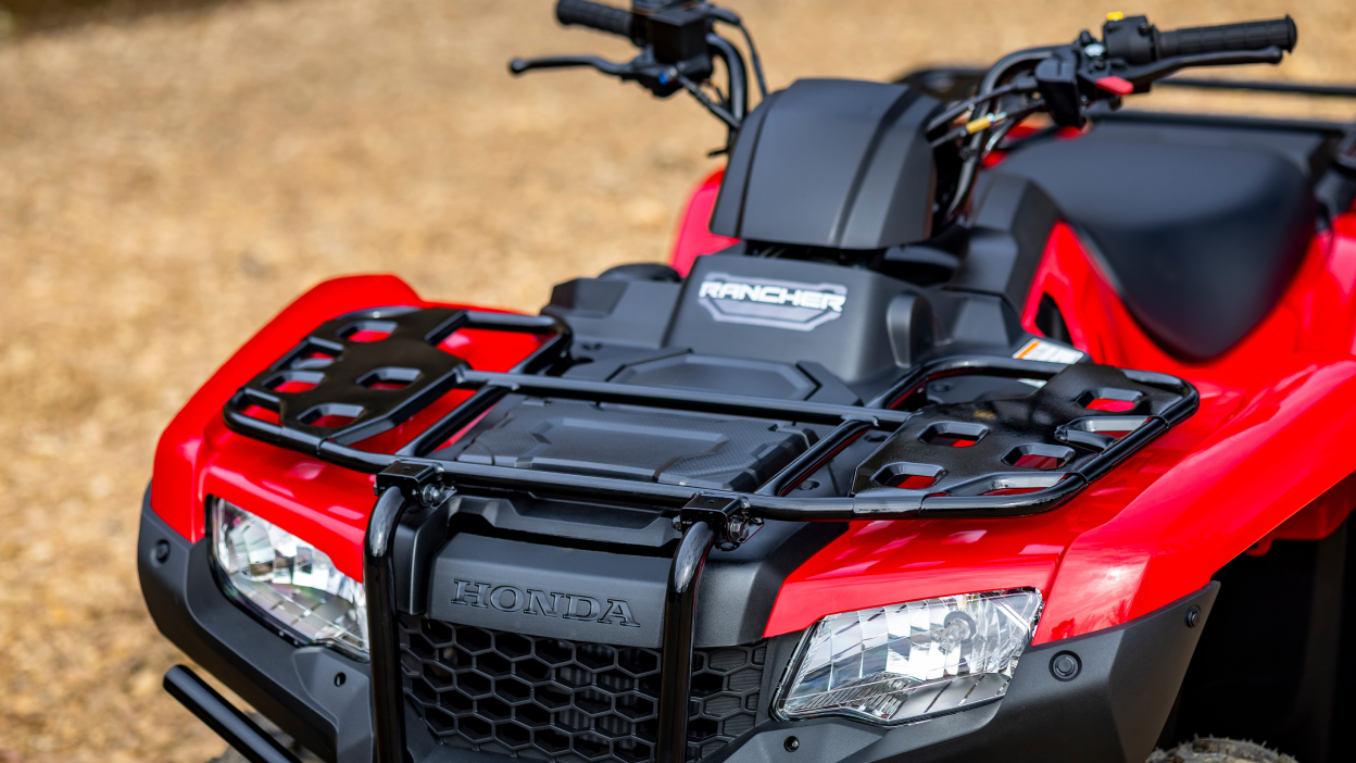 Front facing, close up POV of head lights and handle bars.
