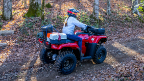 Driver on woodland road, front facing in white jacket. Avenger Red.