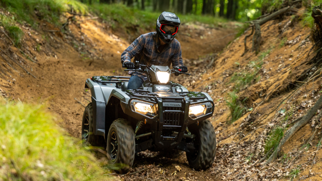 Front view of rider on Rubicon on dirt track.