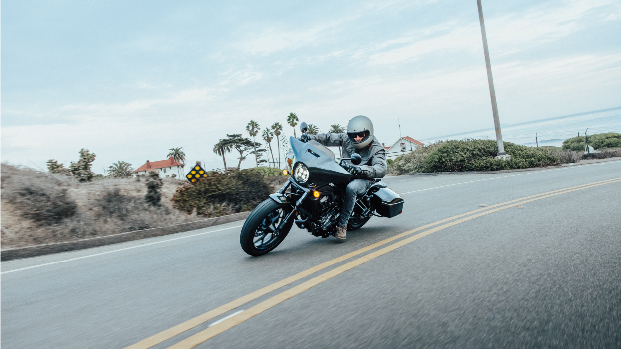 A rider on a Honda Rebel on the highway taking a tight corner