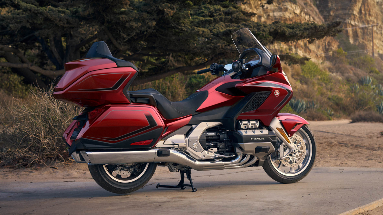 Right facing image of Gold Wing Tour Airbag, stationary on road. Green tree in background.