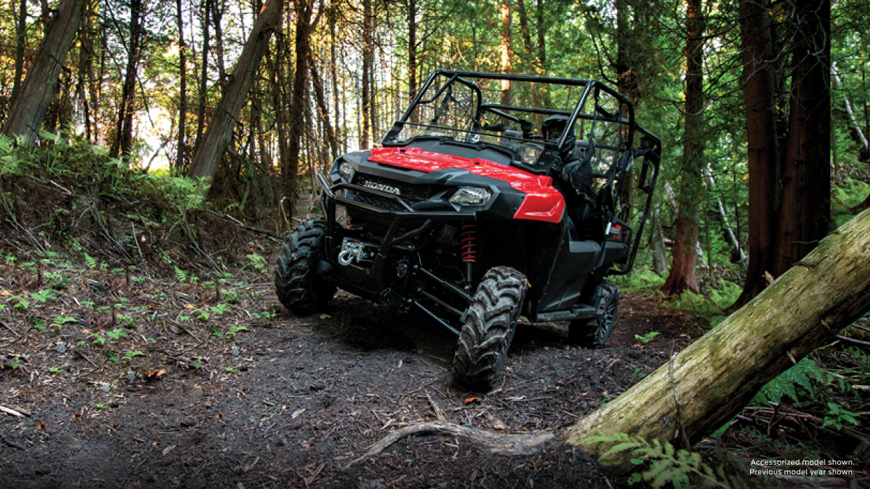 A parked Pioneer 700 beside a wheat field 
