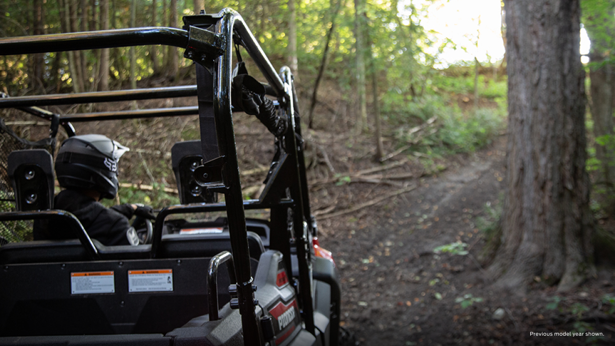 An accessorized Honda Pioneer with a plow