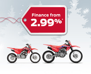 Two CRF Trail bikes on a winter background with snowflakes, with a red gift tag advertising a 2.99% interest rate