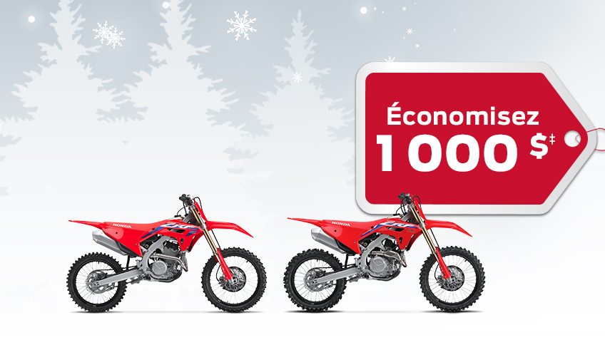 2 vélos de compétition CRF sur un fond d'hiver avec des flocons de neige, avec une étiquette de cadeau rouge annonçant un rabais de 1000 $